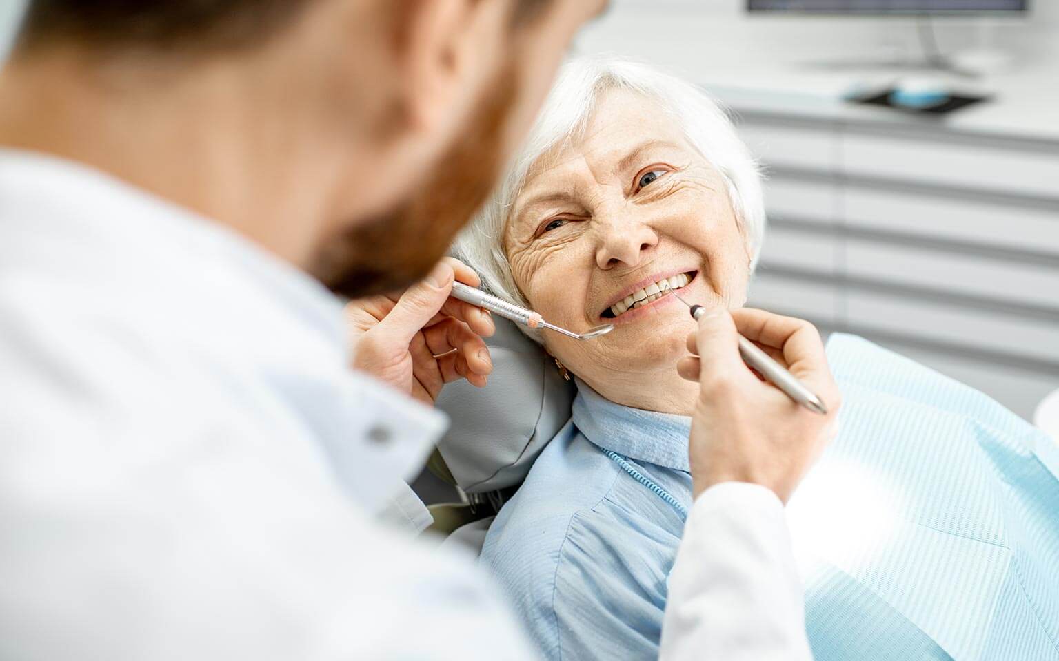 Elderly woman receiving dental treatment Elderly woman receiving treatment