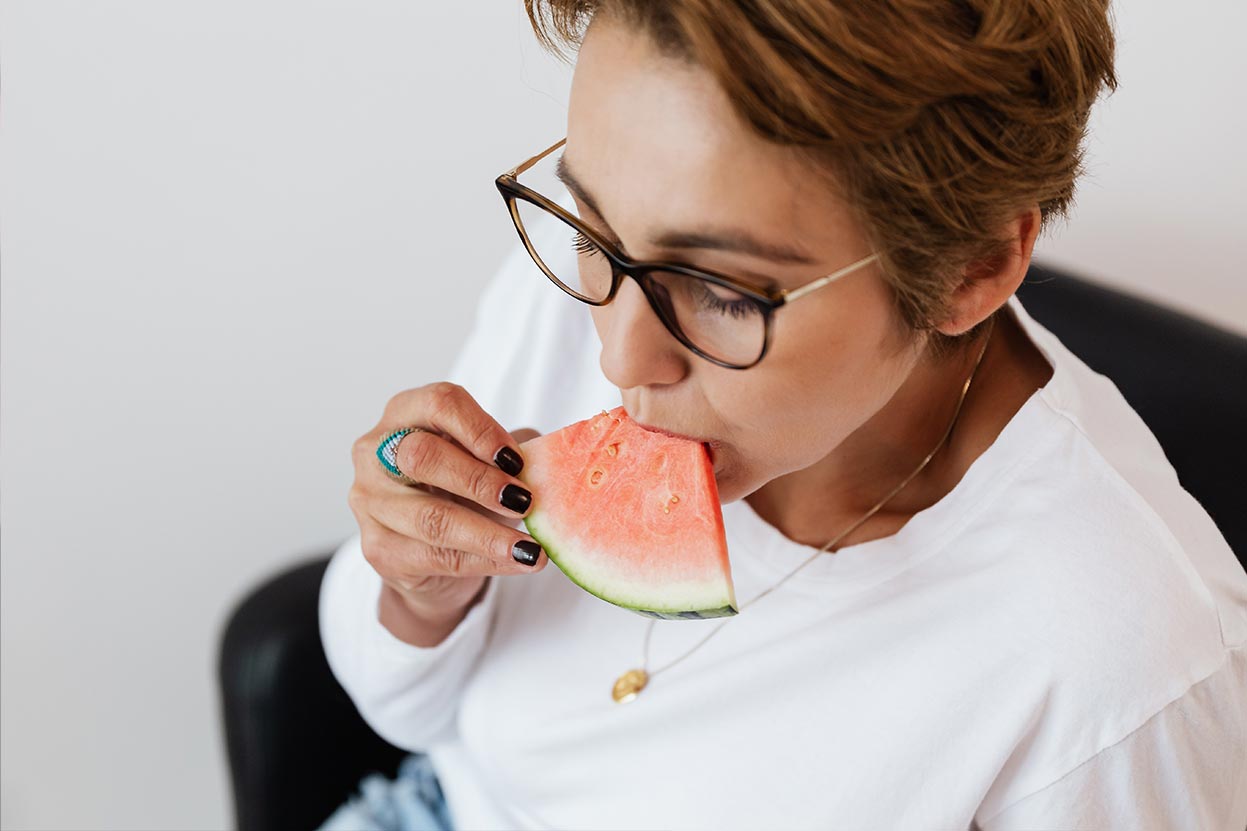 Woman eating melon with dentures